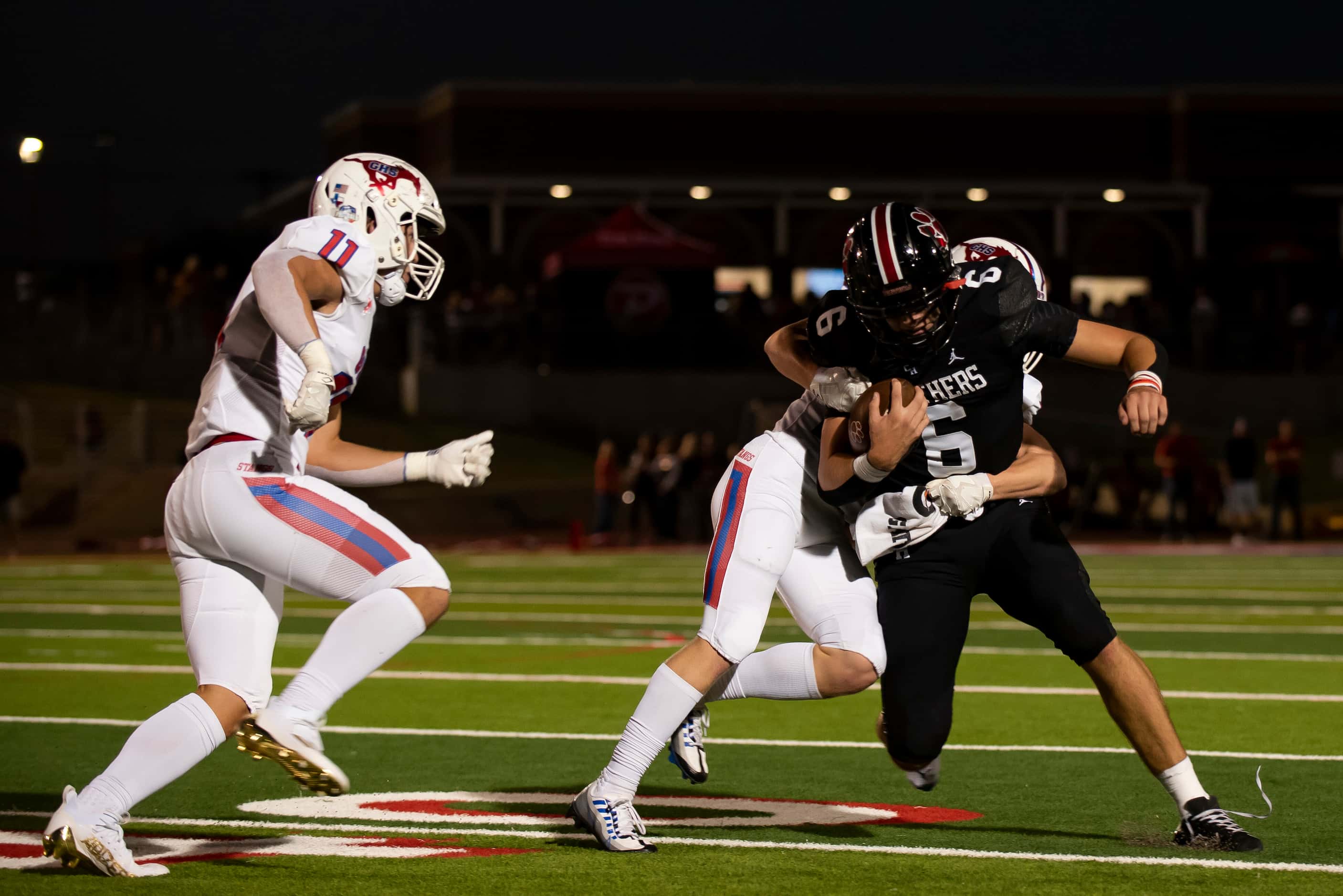 Colleyville senior Weston Smith (6) is tackled by Grapevine senior Hunter Lasher (25) during...