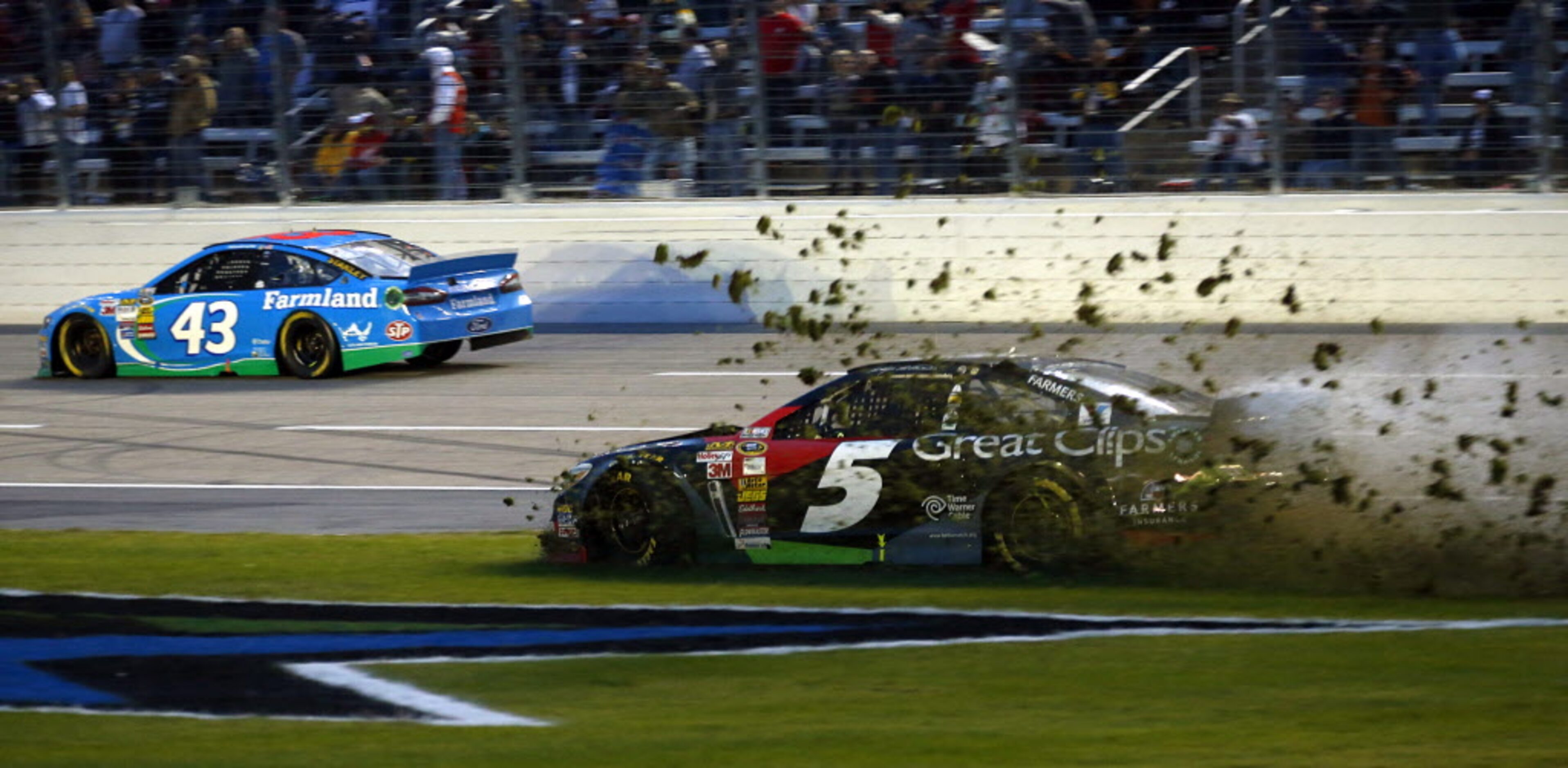 Sprint Cup Series driver Kasey Kahne (5) mows through the infield near the end of the AAA...