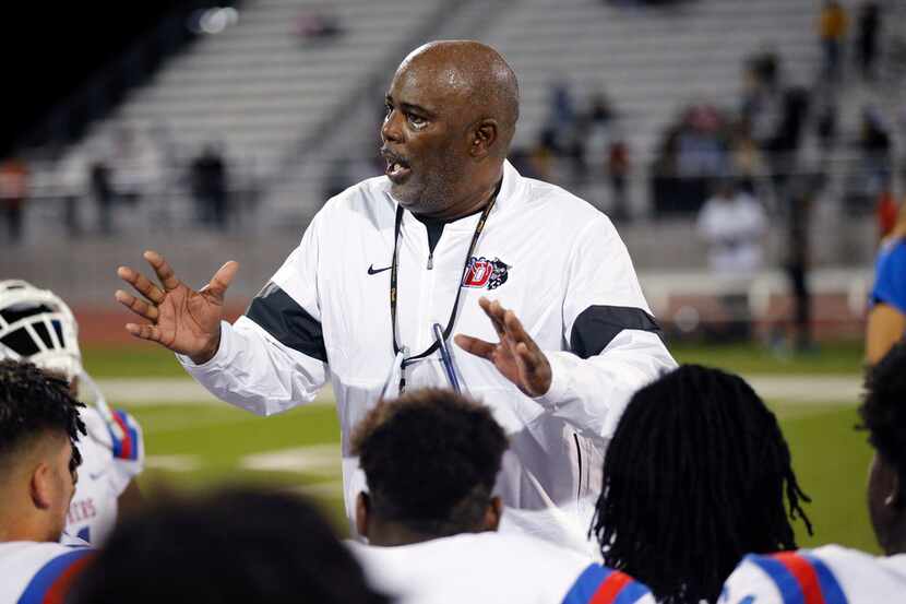 Duncanville head coach Reginald Samples gathers his players together for a postgame huddle...