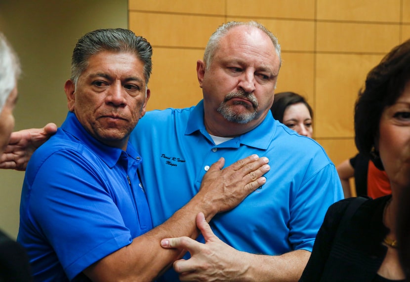 Midland, Texas Mayor Jerry Morales, left, embraces Odessa, Texas Mayor David Turner...