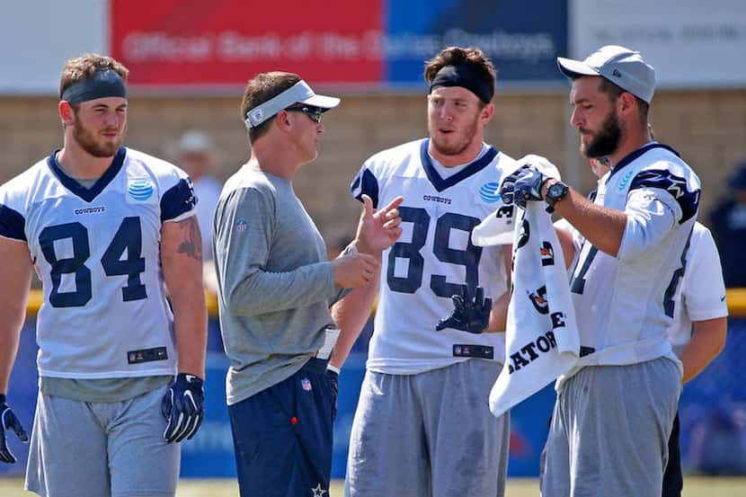 Cowboys tight ends coach Doug Nussmeier (second from left) talks to David Wells (84), Blake...