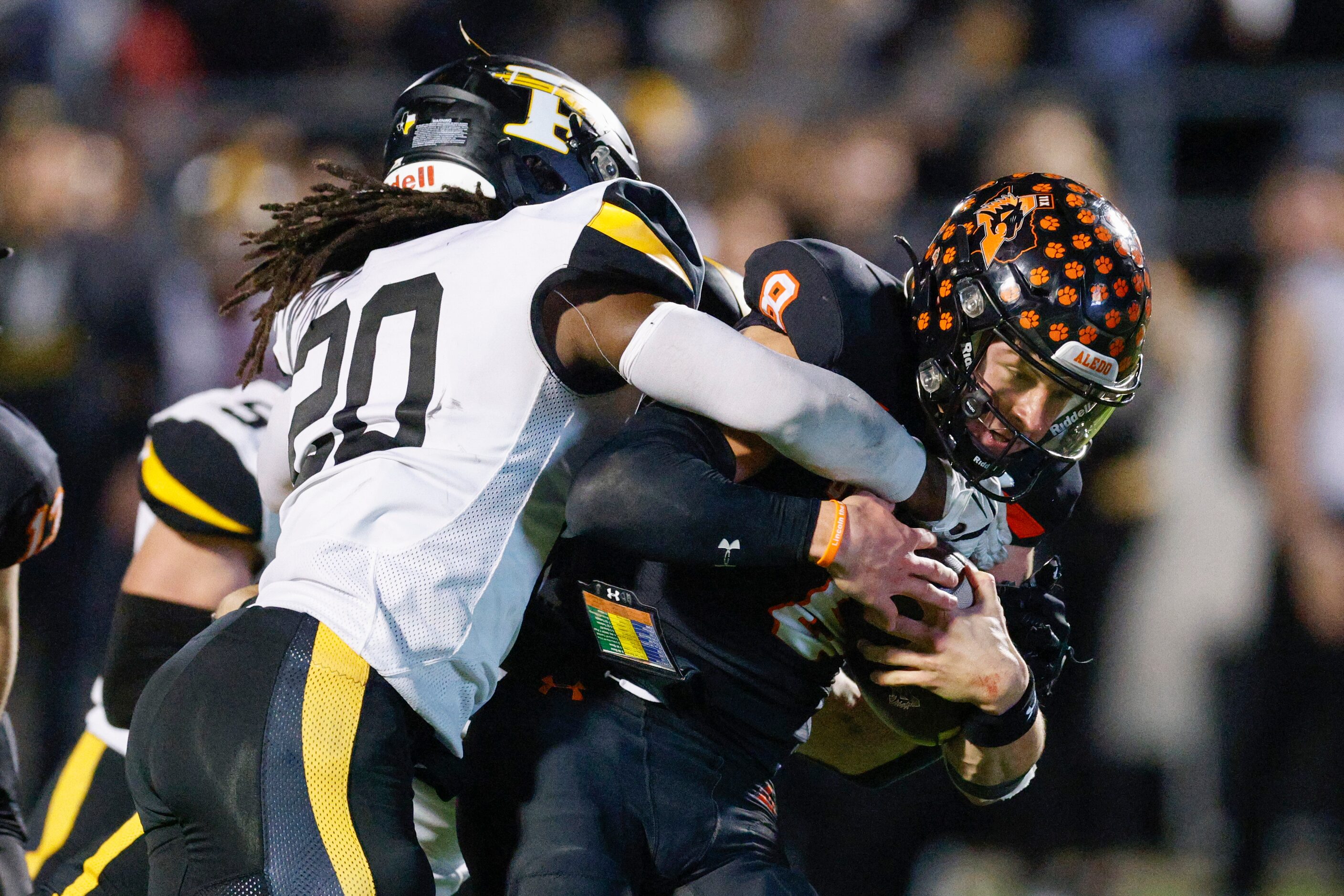 Forney linebacker Xzavier Young (20) tackles Aledo quarterback Hauss Hejny (8) during the...