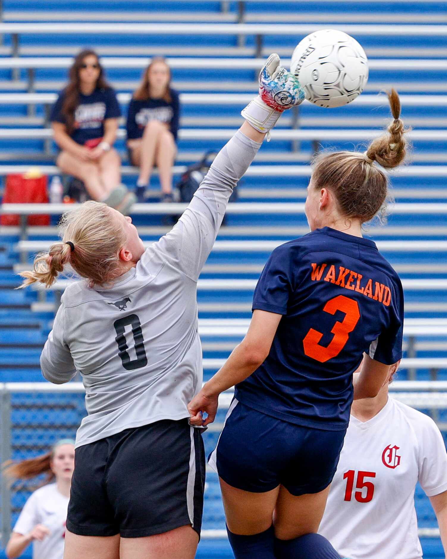 Grapevine goalkeeper Addison Williams (0) punches the ball away from Frisco Wakeland...