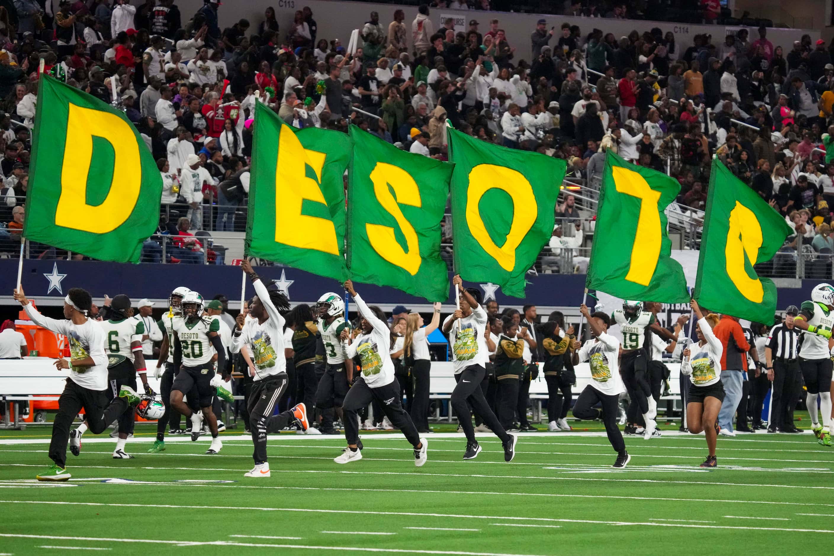 DeSoto flag runners lead the team as they take the field the Class 6A Division II state...