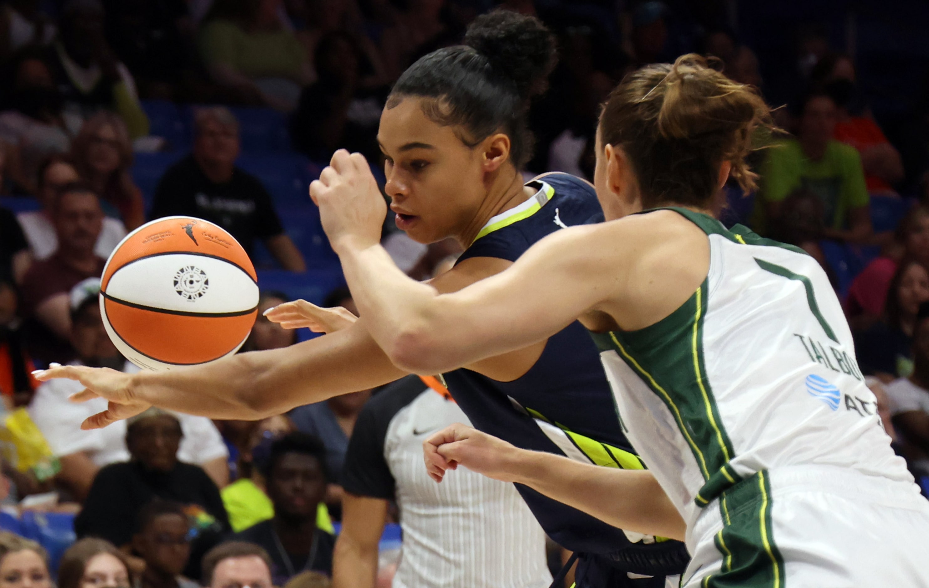 Dallas Wings forward Satou Sabally (0) eyes the ball as she works against the defense of...