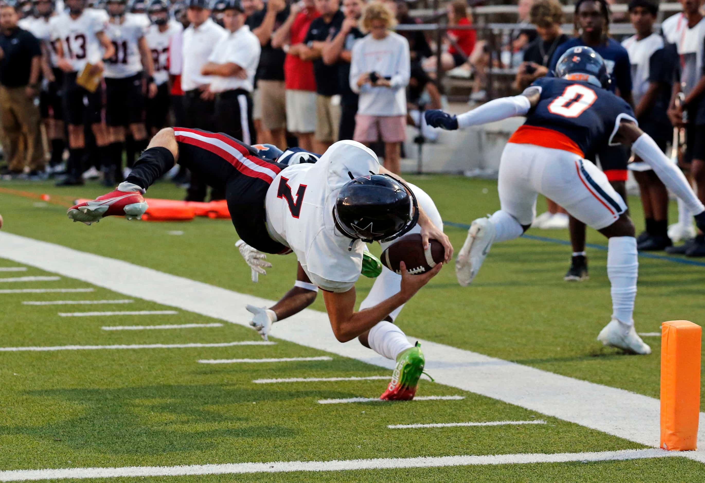 Coppell QB Jack Fishpaw (7) flies horizontal to take the ball to the one-yard-line during...