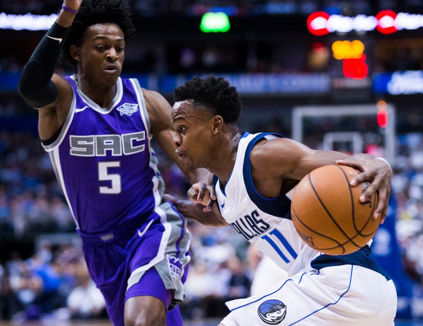 Dallas Mavericks guard Yogi Ferrell (11) gets past Sacramento Kings guard De'Aaron Fox (5)...