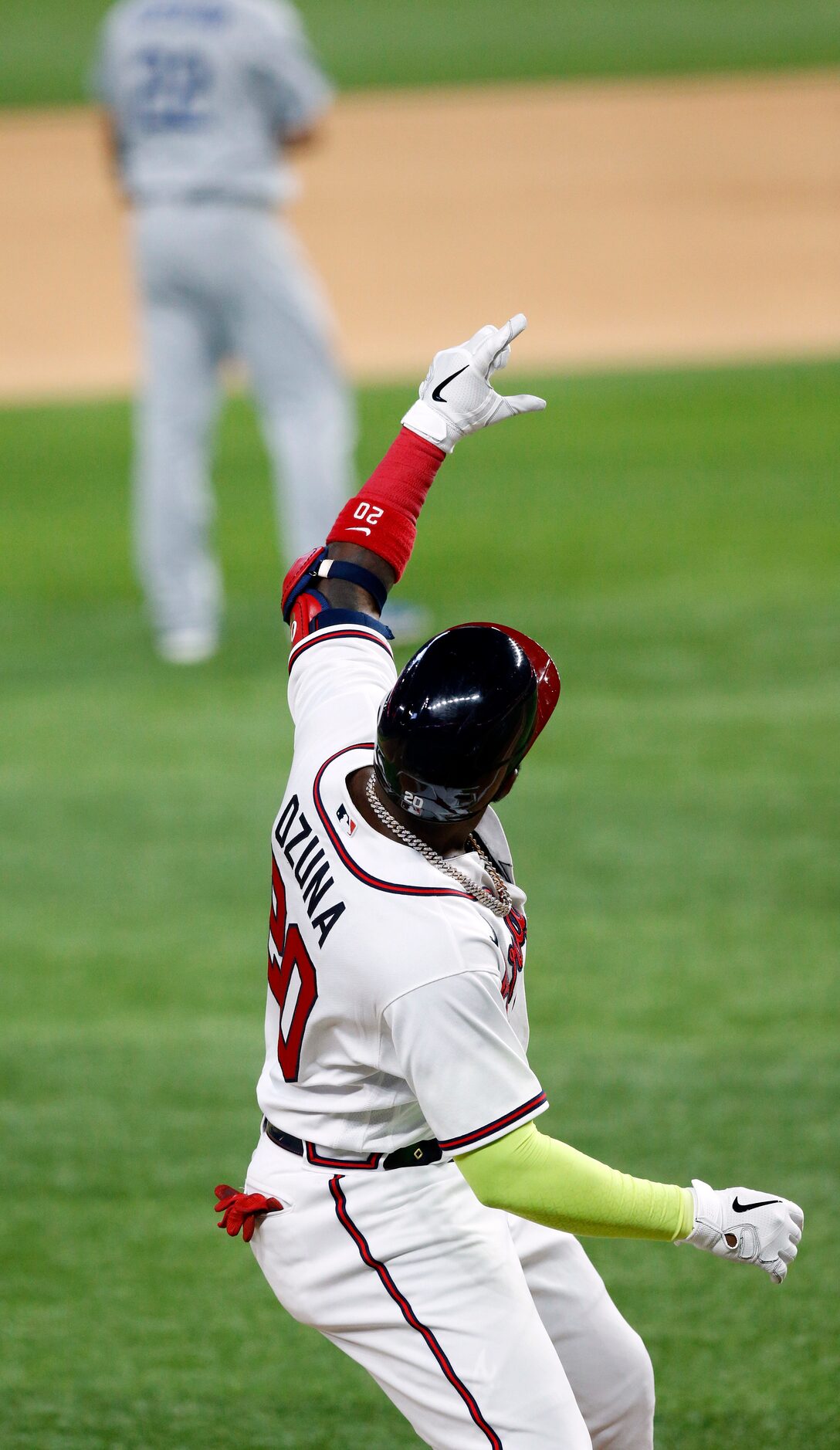 Atlanta Braves designated hitter Marcell Ozuna (20) strikes a pose at third base after his...