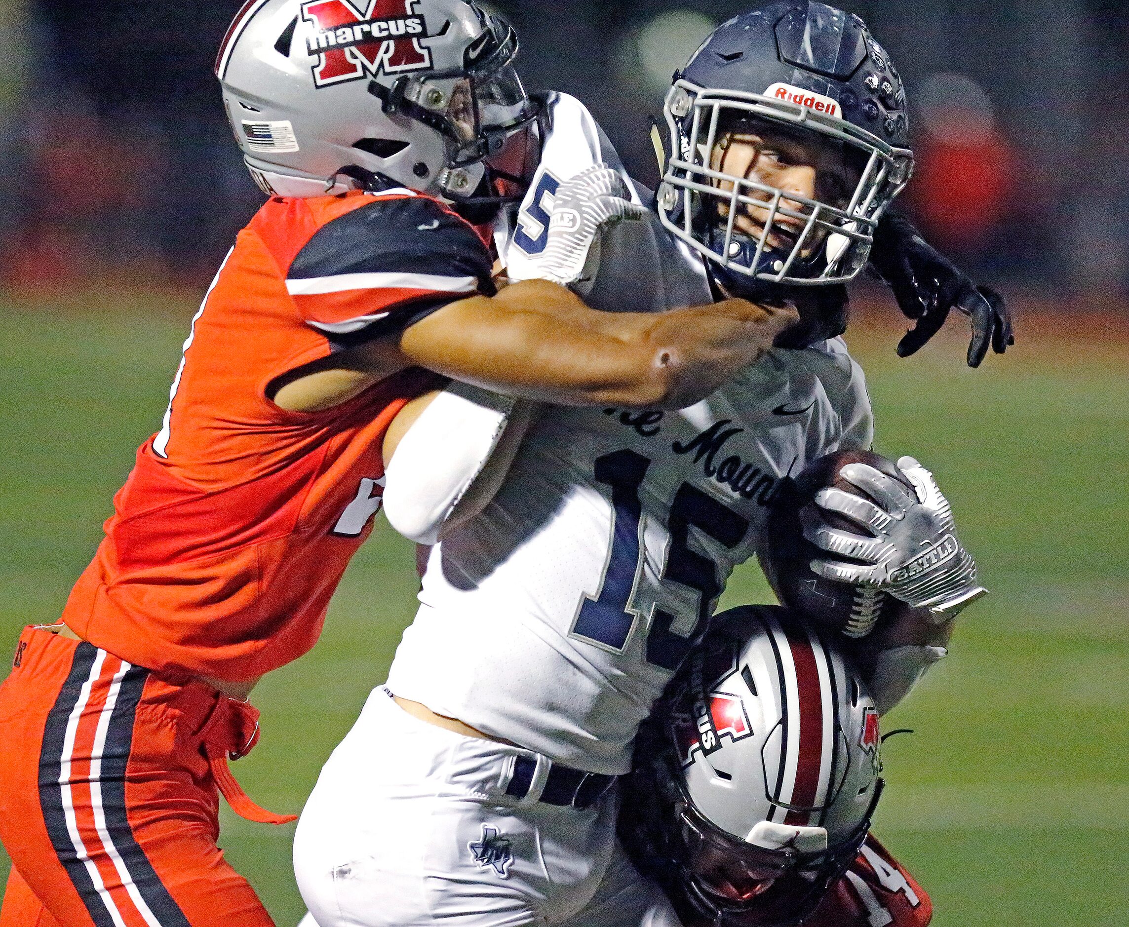 Flower Mound Marcus High School defensive back Zach Morris (21) wraps up Flower Mound High...