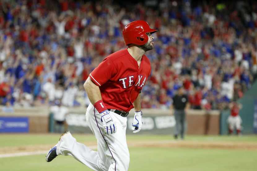 Texas Rangers first baseman Mitch Moreland watches his walk off solo home run during the 9th...
