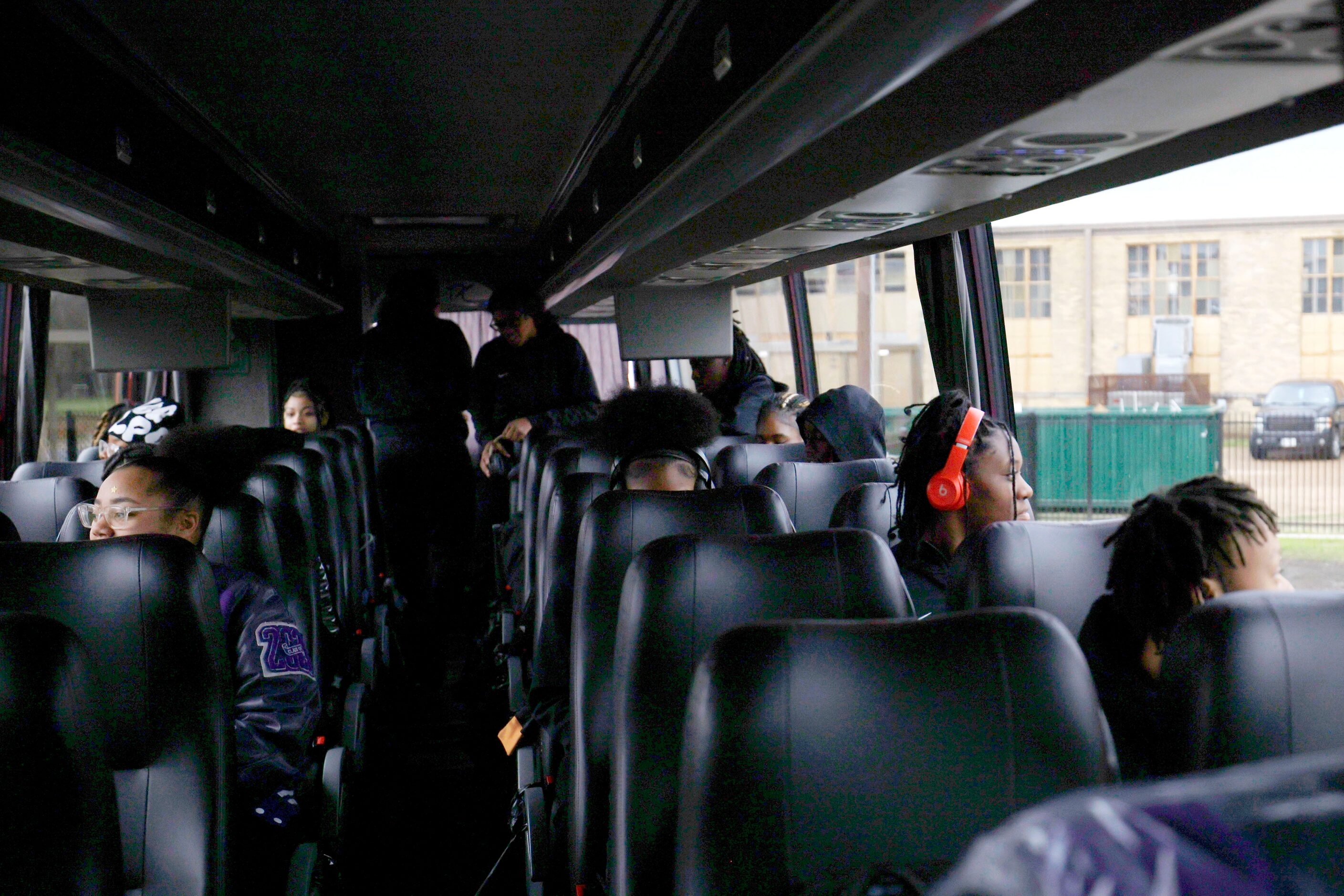 Lincoln High School basketball players sit inside a bus after a send-off event for the...