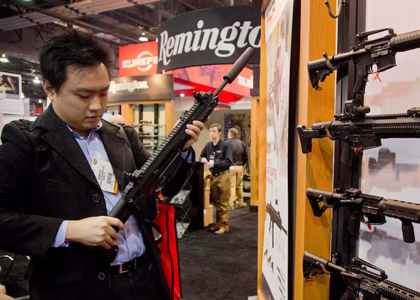 Accessories manufacturer Kevin Kao, of Irvine, Calif., examines a military grade Remington...