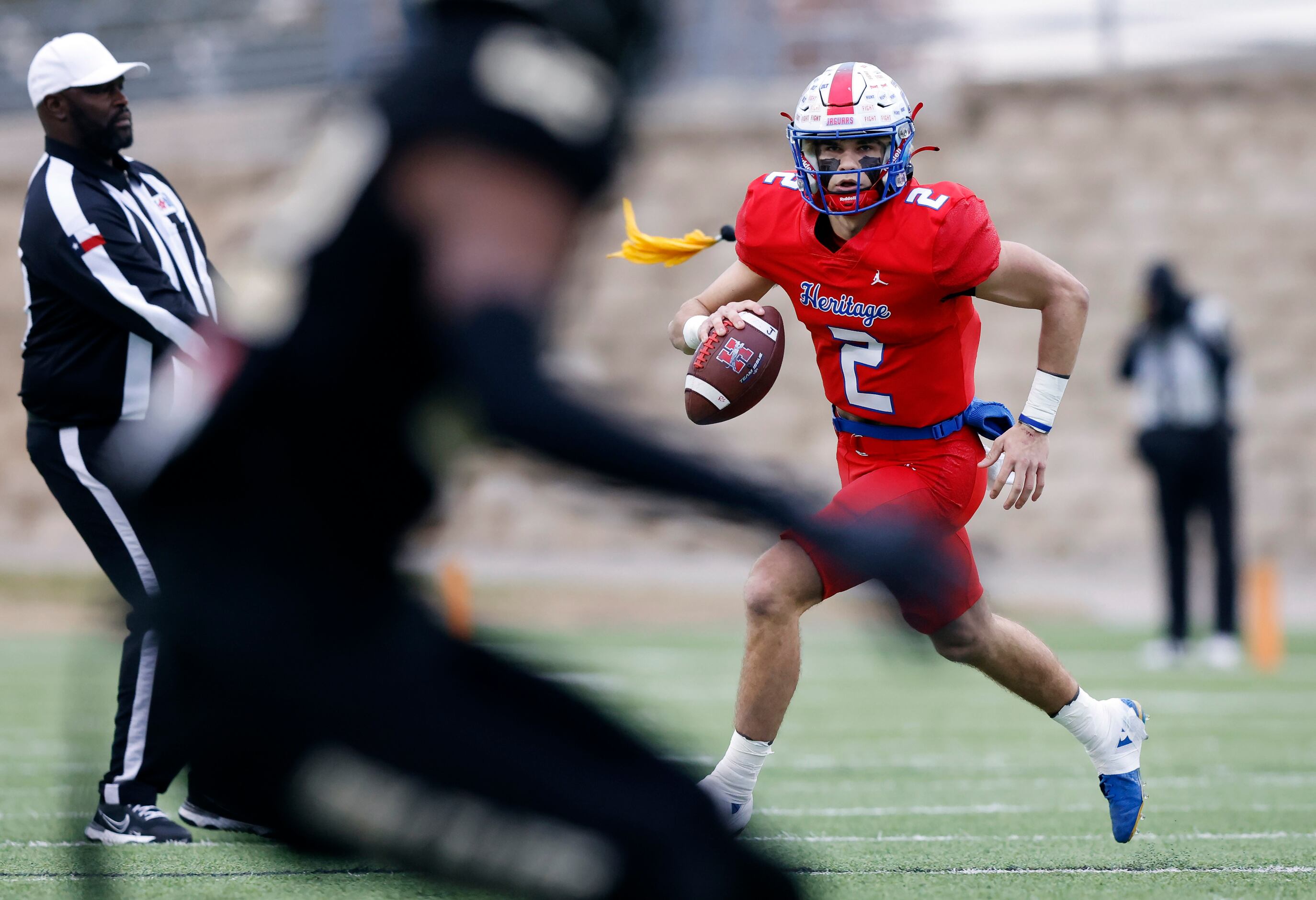 Midlothian Heritage quarterback Kaden Brown (2) looks for a receiver as a flag is thrown...