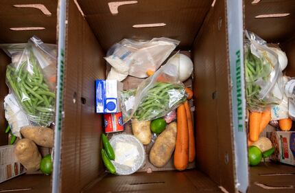 Boxes are filled with ingredients that will be taken home and used by Dallas College...