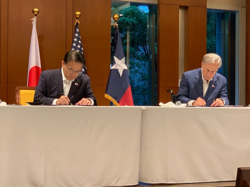 Texas Gov. Greg Abbott signs an economic development agreement with Hideaki Omura, governor...