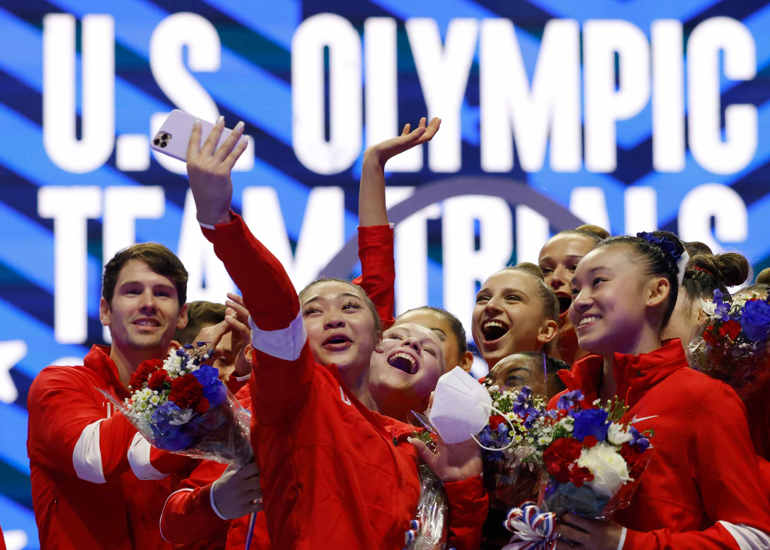 Sunisa Lee takes a group photo after the women's U.S. Olympic gymnastics team was announced...