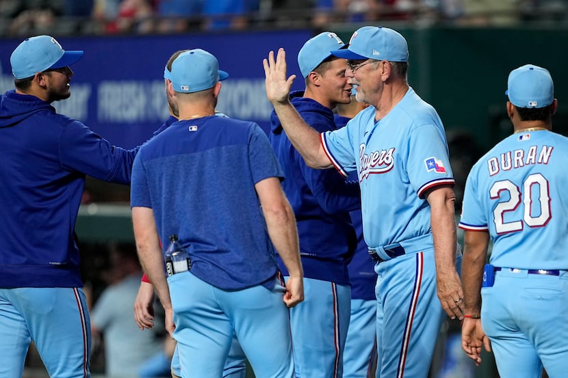 Texas Rangers manager Bruce Bochy, second from right, celebrates with Martin Perez, left,...
