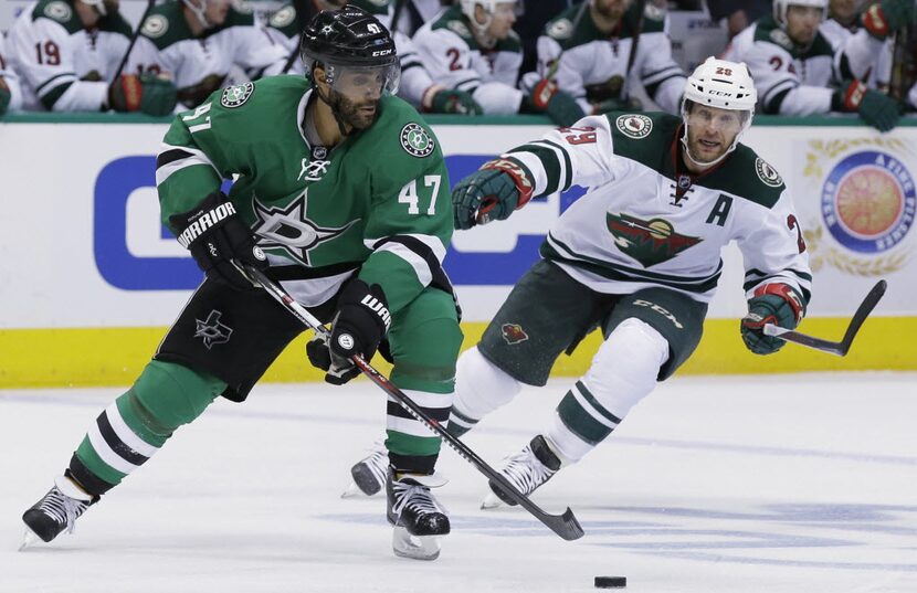 Dallas Stars defenseman Johnny Oduya (47) skates with the puck against Minnesota Wild right...