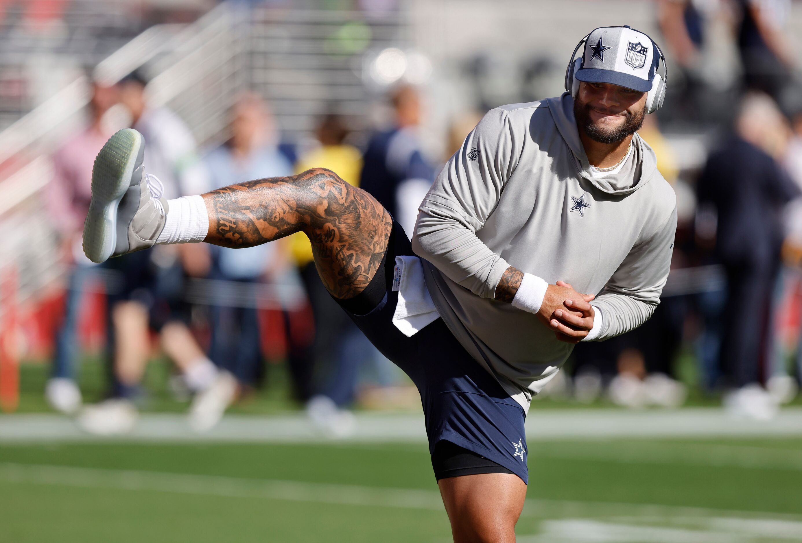 Dallas Cowboys quarterback Dak Prescott (4) stretches during pregame warmups before facing...