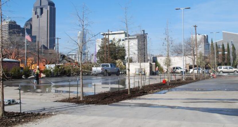 Construction workers clean the parking lot at Dallas CASA’s new offices. CASA workers...