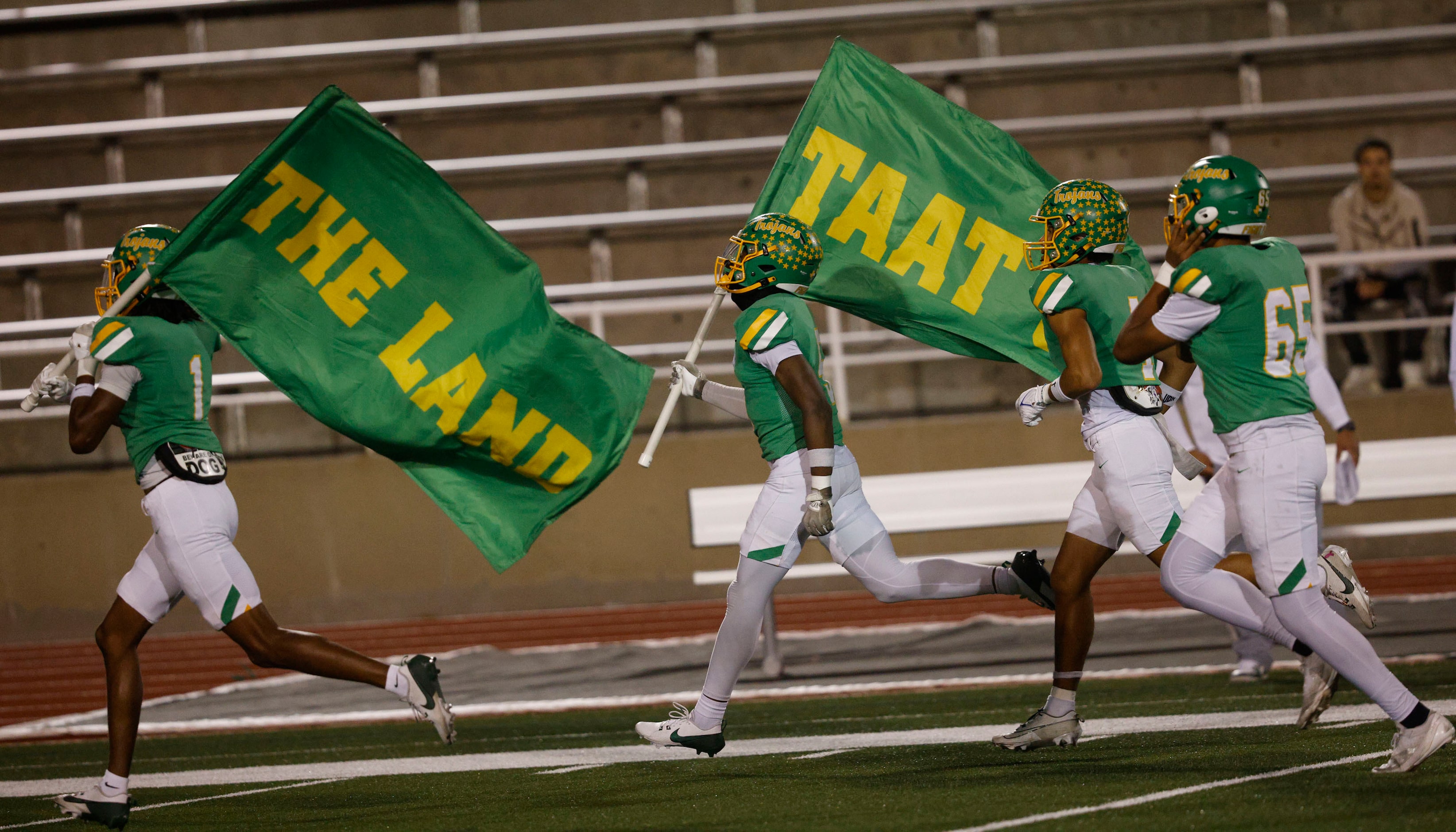 Newman Smith players run onto the field before a high school football game against West...