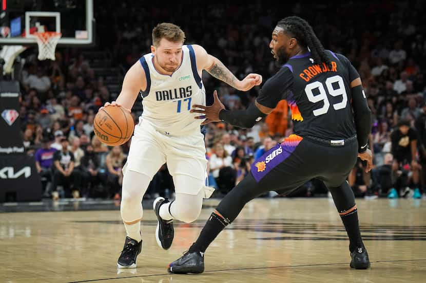 Dallas Mavericks guard Luka Doncic (77) dribbles around Phoenix Suns forward Jae Crowder...