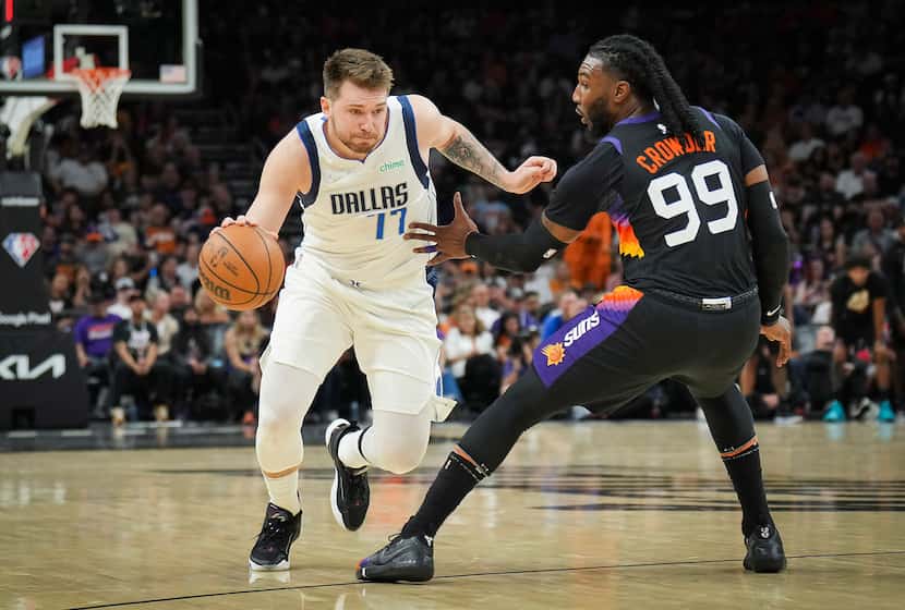Dallas Mavericks guard Luka Doncic (77) dribbles around Phoenix Suns forward Jae Crowder...