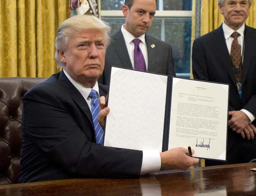 Trump shows the executive order withdrawing the U.S. from the Trans-Pacific Partnership on...