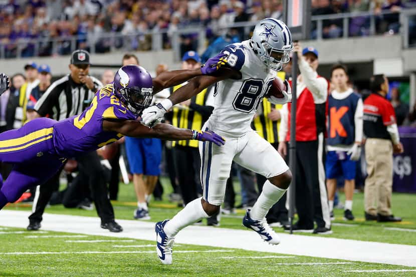 Dallas Cowboys wide receiver Dez Bryant (88) gets away from a tackle by Minnesota Vikings...