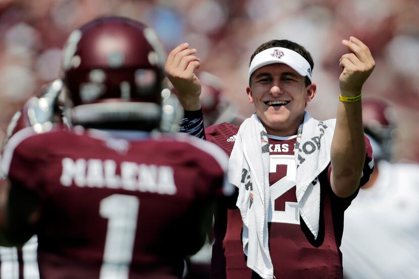 Texas A&M's Johnny Manziel, right, celebrates a touchdown by teammate Ben Malena (1) during...