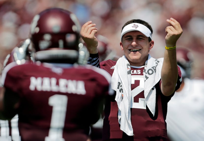 Texas A&M's Johnny Manziel, right, celebrates a touchdown by teammate Ben Malena (1) during...