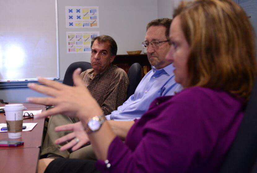 Grief counseling members (from front) Julie Dunn, Mark Small and Drew Alexandrou participate...