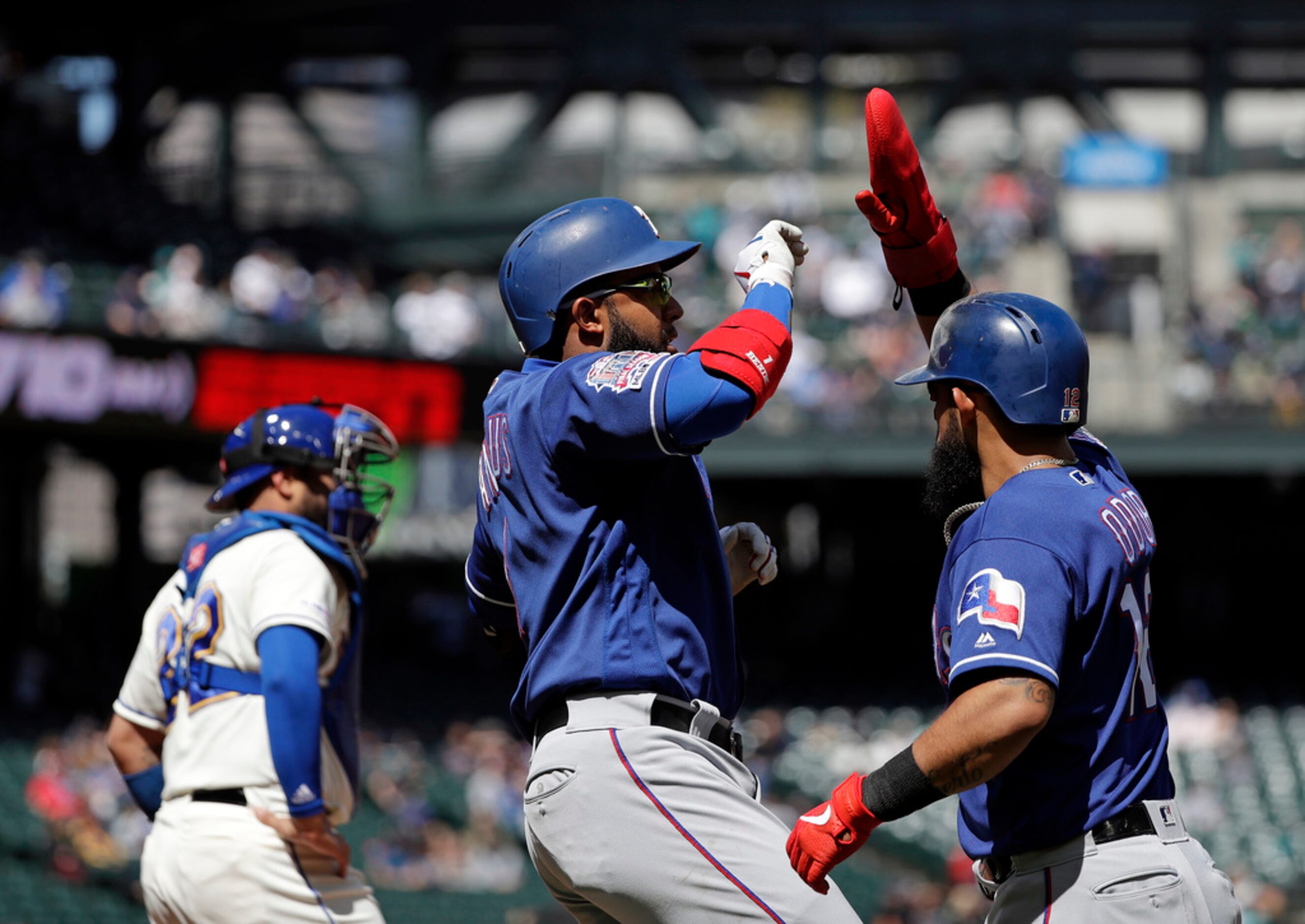 Texas Rangers' Elvis Andrus, center, celebrates his two-run home run with Rougned Odor as...