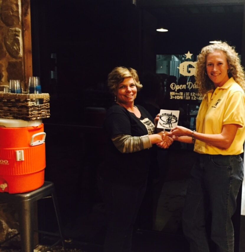 Kelly "K2" Richards, RRCA Director-at-Large (right), presents  "Runner-Friendly" decals to...