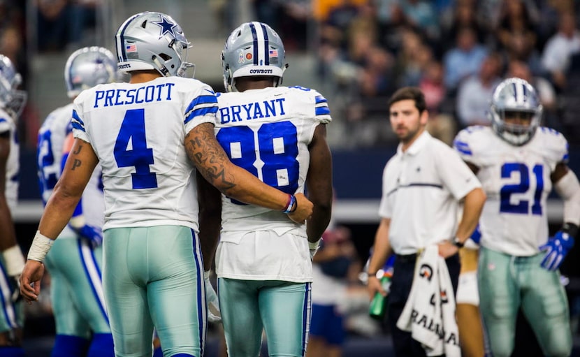 Dallas Cowboys quarterback Dak Prescott (4) hugs wide receiver Dez Bryant (88) before a play...