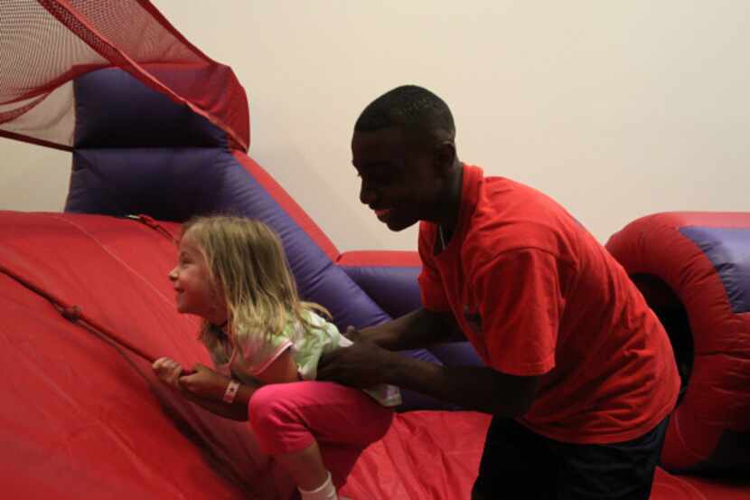 Savanah Caruth, 5 and worker Jason Rone play together at BounceU as part of a birthday party...