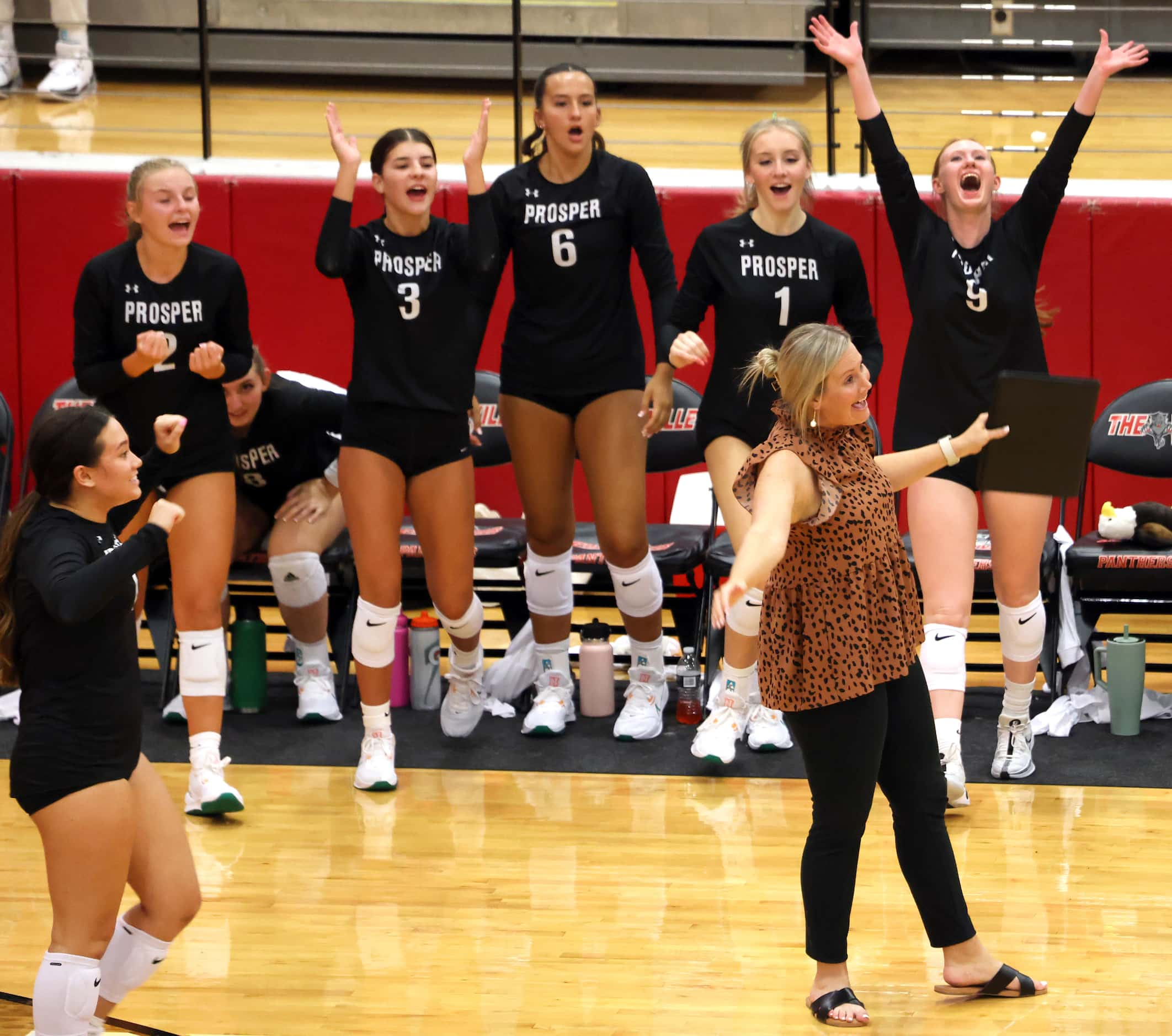 Prosper head volleyball coach Toree Winchell, lower right, reacts with the team bench after...