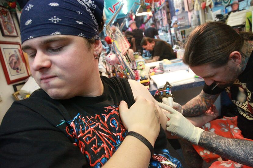 Andrew Hinojosa grimaced while getting a tattoo from Oliver Peck during a 24-hour tattoo...