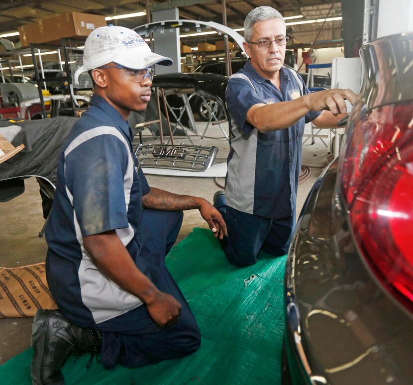 
Apprentice supervisor Ralph Gonzales inspects the work of Service King apprentice Kenneth...