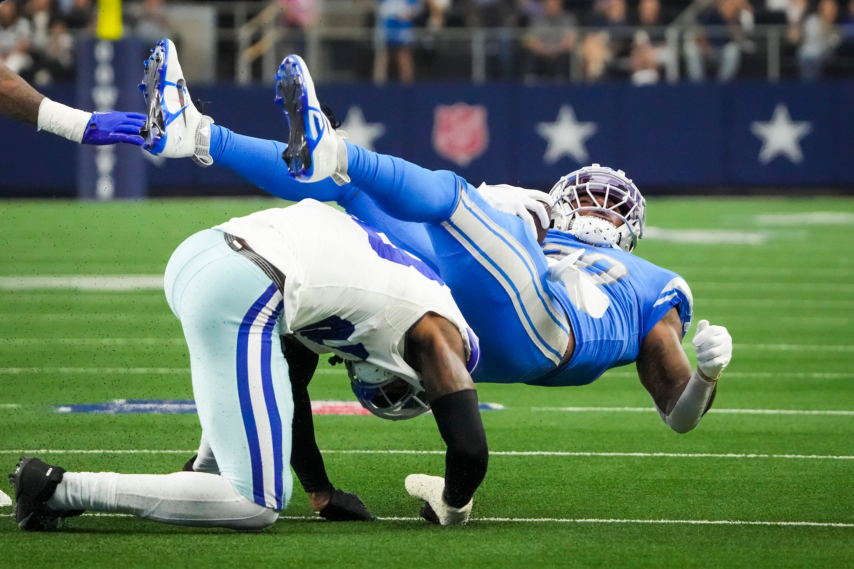 Detroit Lions running back Jamaal Williams (30) is brought down by Dallas Cowboys safety...