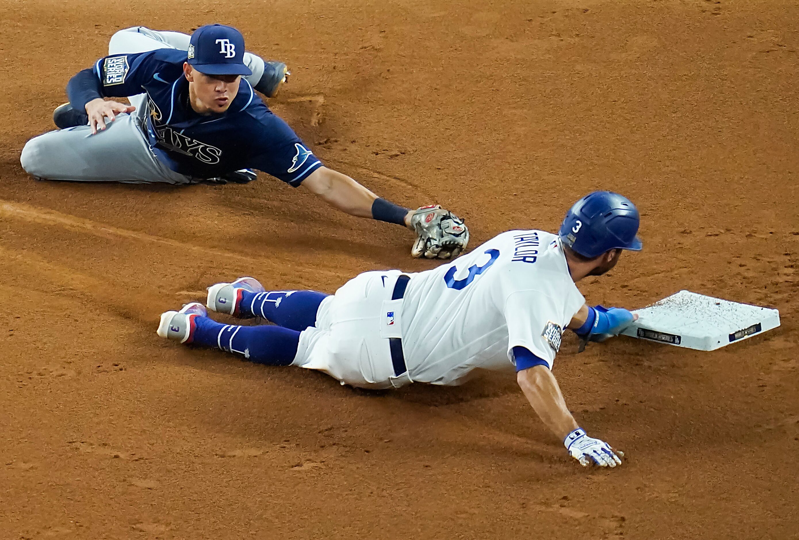 Los Angeles Dodgers second baseman Chris Taylor is safe at second base advancing on a wild...