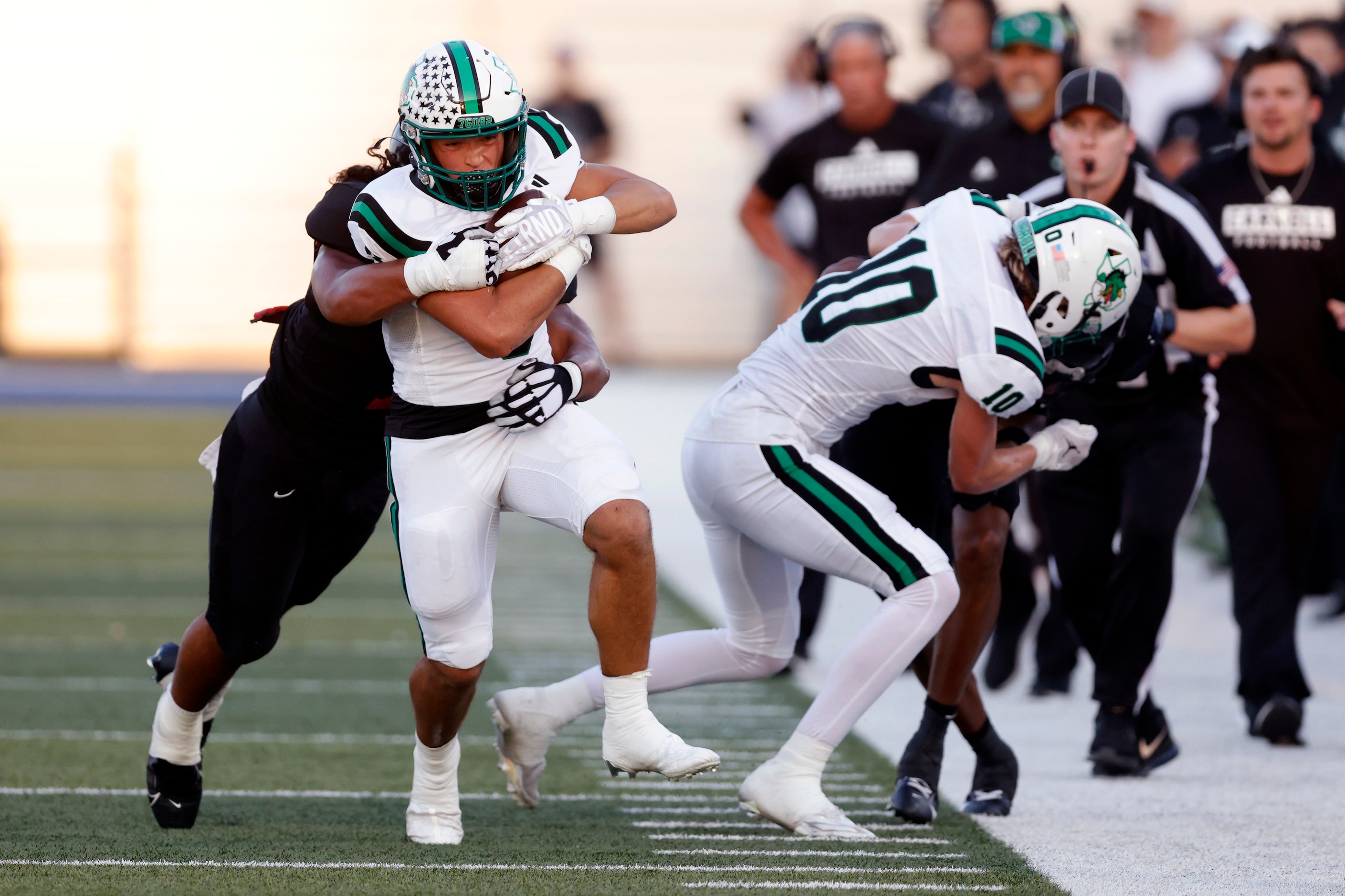 Euless Trinity linebacker Gordon Mohetau (7) tackles Southlake Carroll running back Davis...