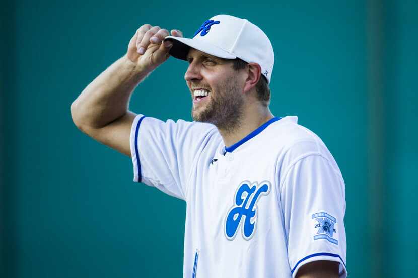 Dallas Mavericks power forward Dirk Nowitzki smiles at first base during the first inning of...