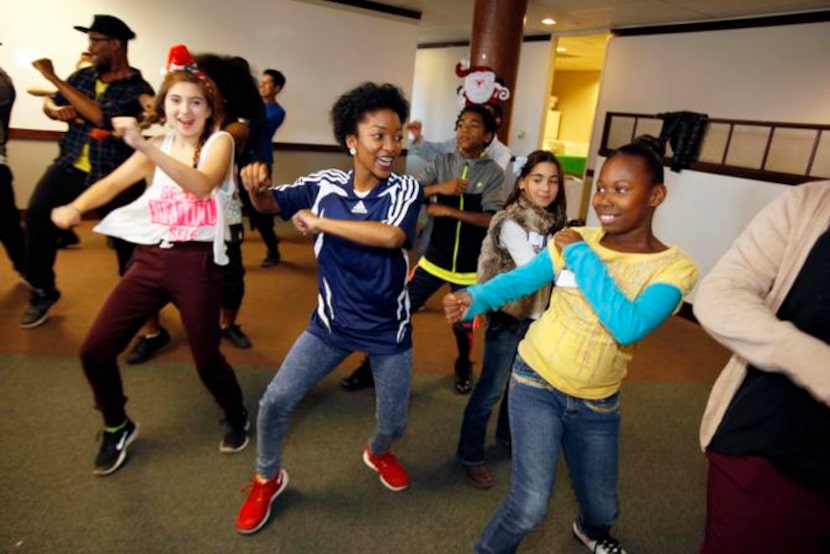 
PATIENT DIAMOND ELLIS, 8, right, dances with Schuyler Jackson, 16, and Charlotte Posey, 14,...