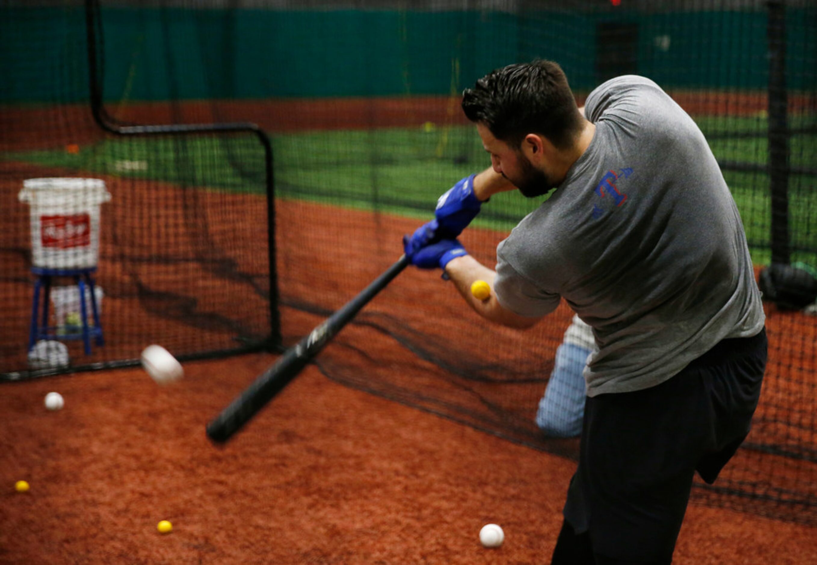 Texas Rangers Joey Gallo (13) works with ball in the elbow area as he hits another ball...