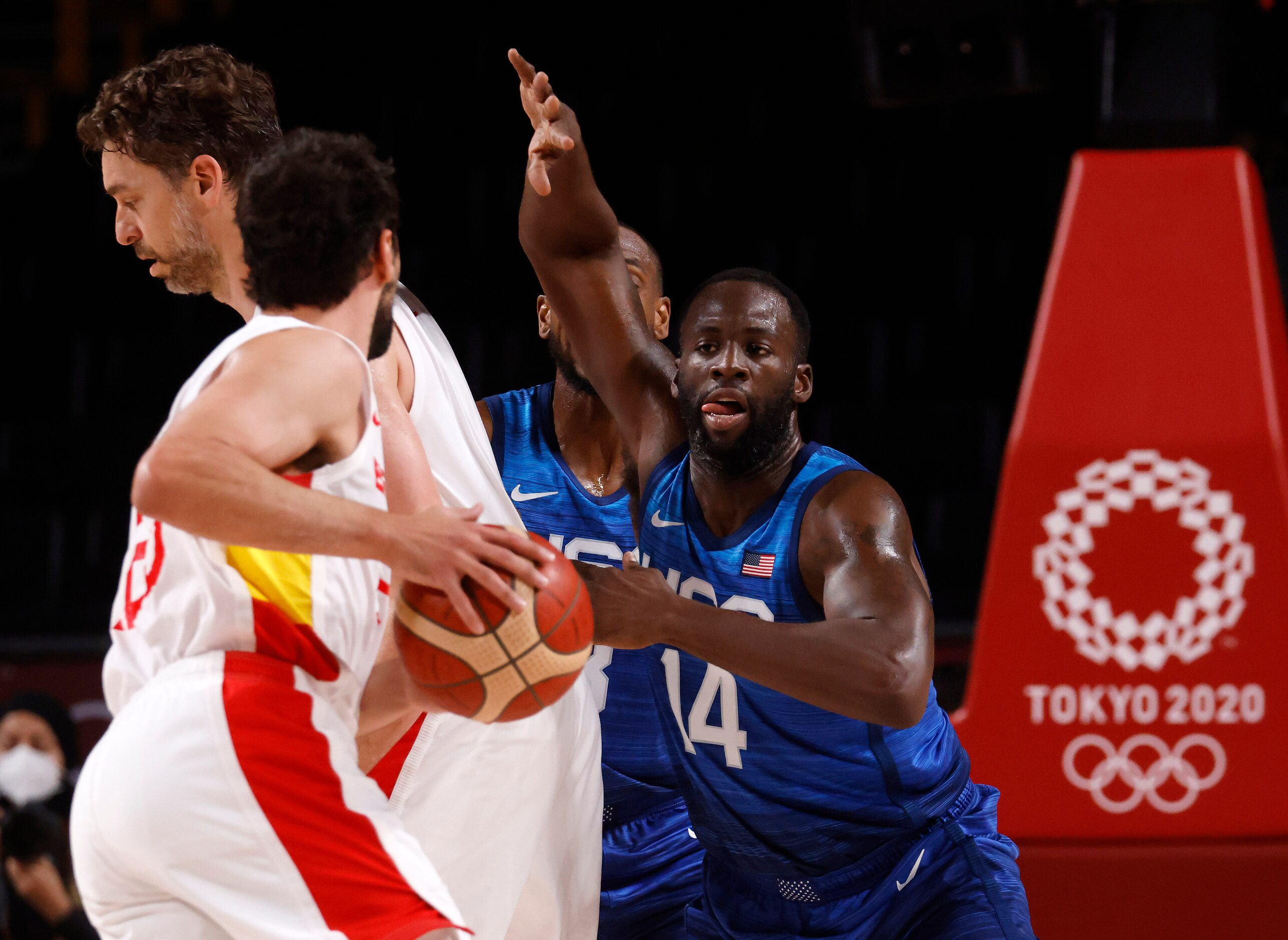 USA’s Draymond Green (14) defends as Spain’s Sergio Llull (23) looks to advance the ball...