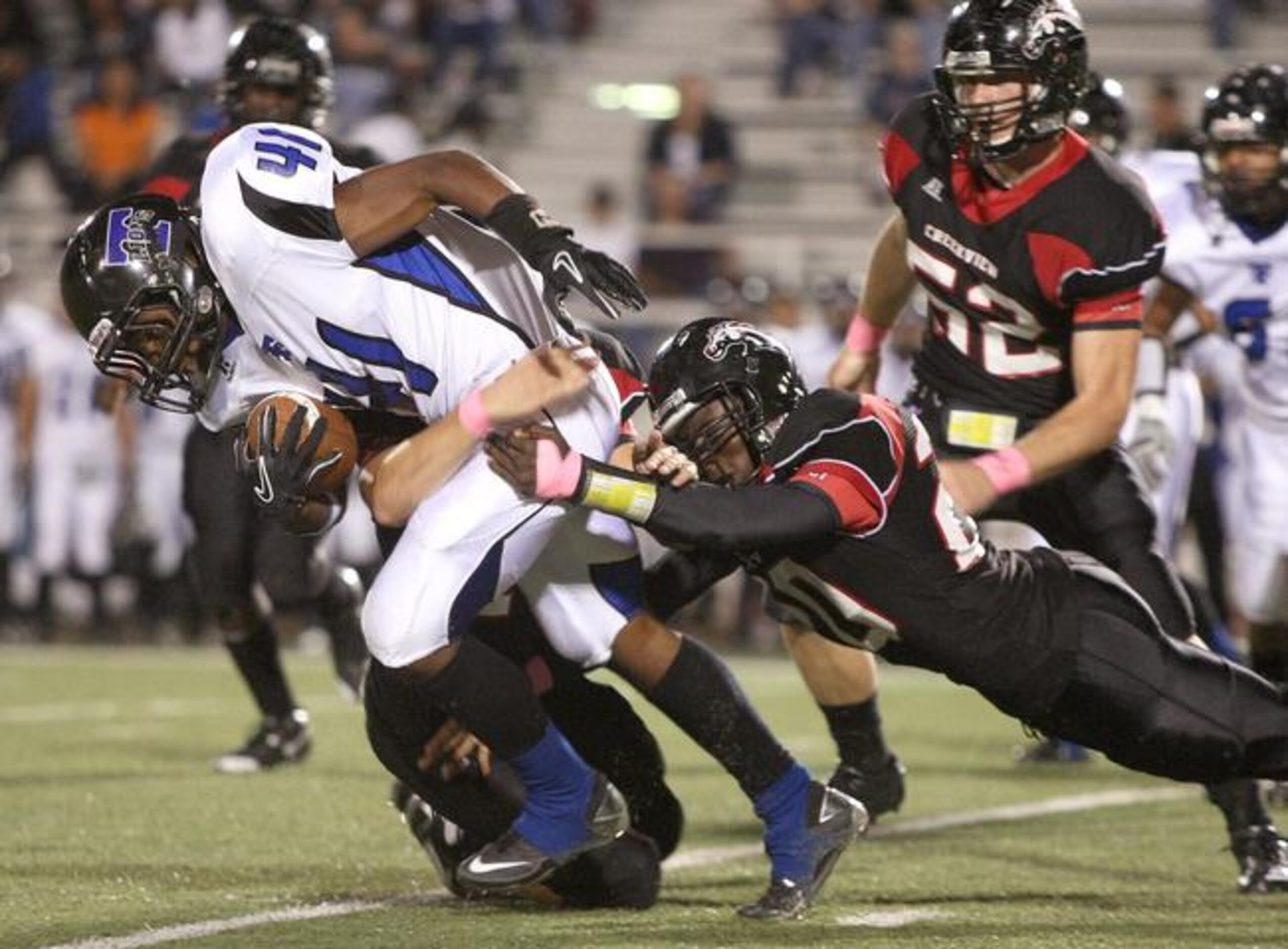 Creekview sophomore linebacker Johnny Jones takes down R.L. Turner's James Thomas (41),...