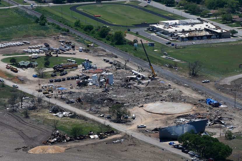 The damage from the fertilizer plant explosion is seen from helicopters in accompanying...