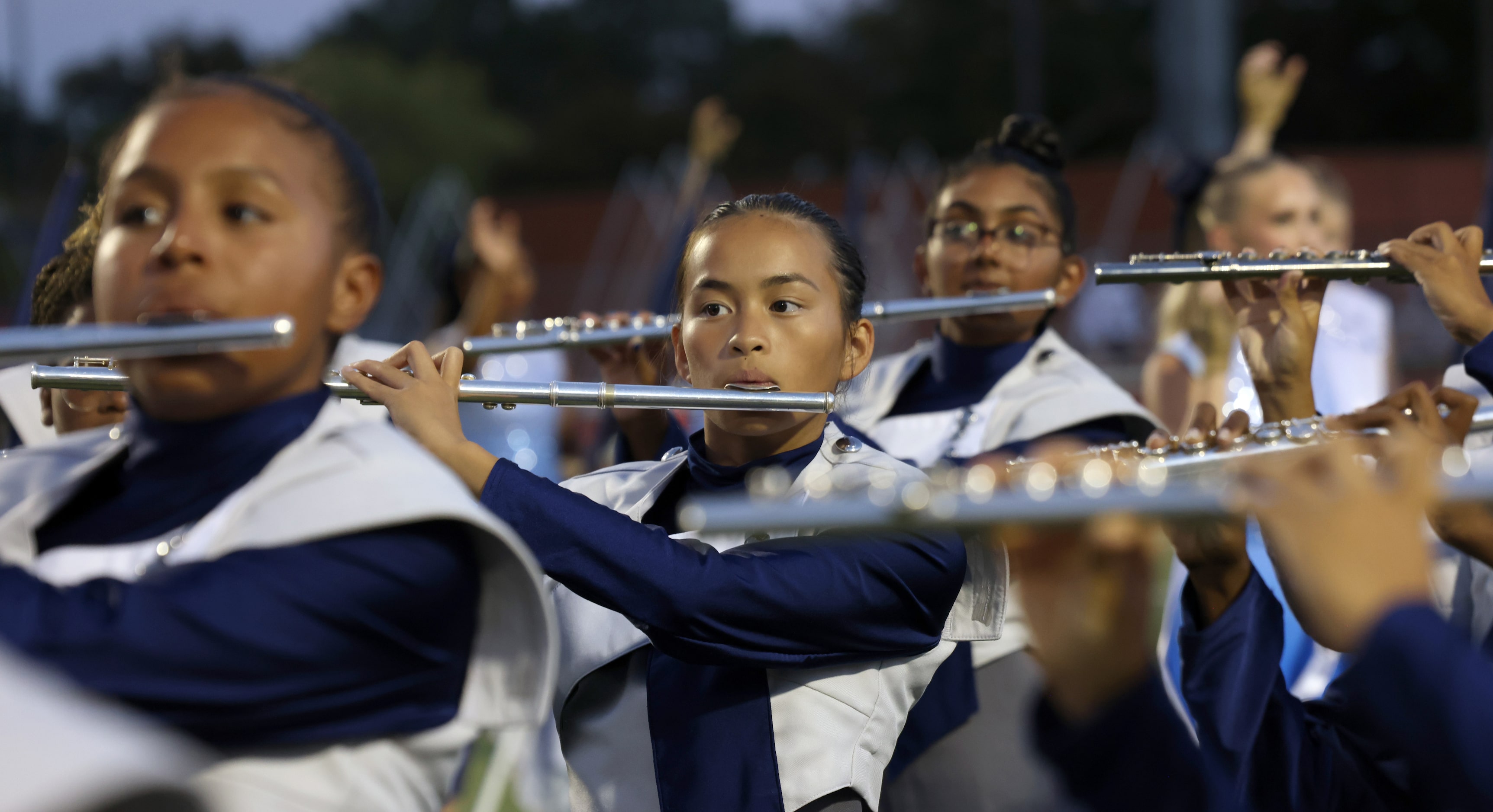 Flower Mound Jaguars band members in the flute section perform on the field prior to the...