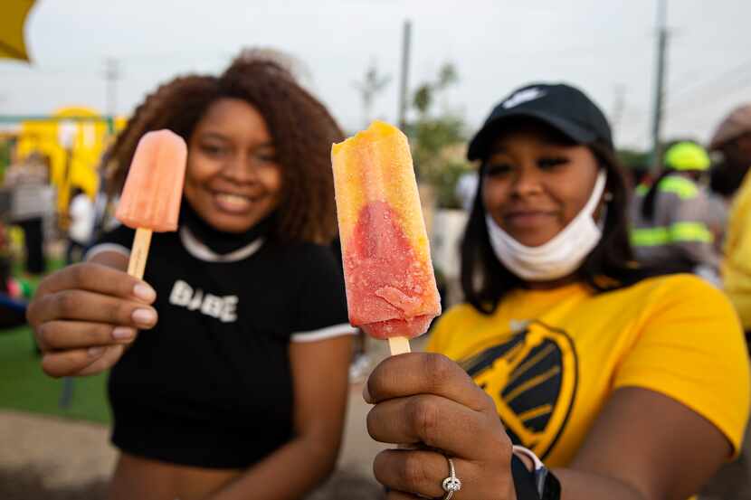 DayJus Hill and Tatiana Laury hold up their popsicles they got from the Frios Gourmet Pops...